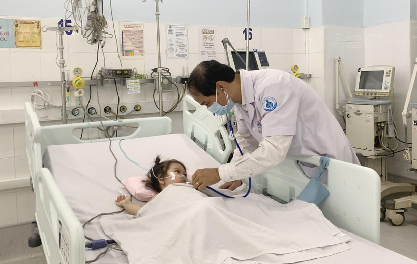 Phó Giáo sư, Tiến sỹ, bác sỹ Phạm Văn Quang, Trưởng Khoa Hồi sức tích cực - chống độc, Bệnh viện Nhi đồng 1 thăm khám cho bệnh nhi. (Ảnh: Đinh Hằng/TTXVN)