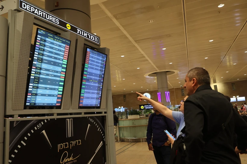 Hành khách theo dõi danh sách các chuyến bay bị hủy trên bảng thông báo tại sân bay . (Ảnh minh họa. AFP/TTXVN)