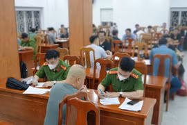 Một số công dân đang khai tờ khai về việc bị trục xuất về nước. (Ảnh: CA Thành phố Hồ Chí Minh cung cấp)