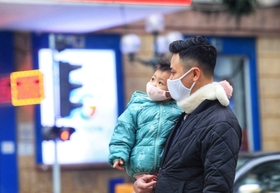 Một em bé được bố đưa đi chơi đi dạo ngày đầu năm trên Hồ Hoàn Kiếm. (Ảnh: Tuấn Anh/TTXVN)