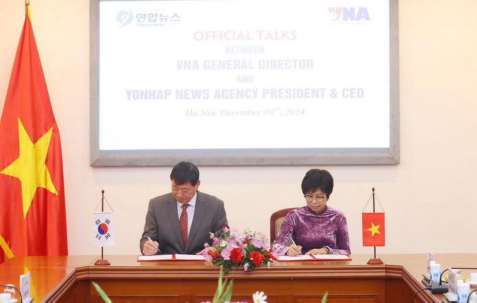 Tổng Giám đốc Thông tấn xã Việt Nam Vũ Việt Trang và Chủ tịch kiêm Giám đốc điều hành Yonhap Hwang Dae-il ký Biên bản hội đàm. (Ảnh: Phạm Kiên/TTXVN)