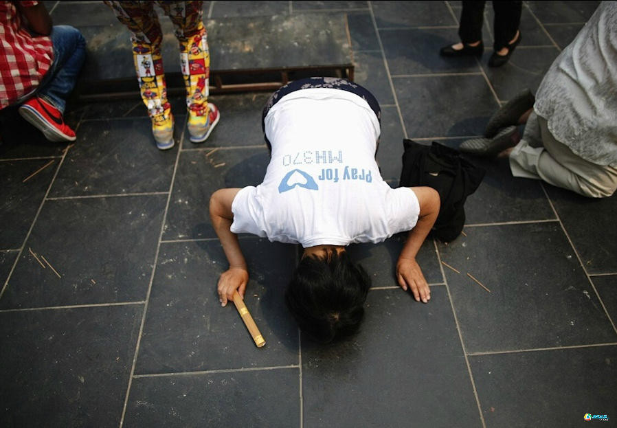 Ngày 15/6/2014, MH370 mất tích tròn 100 ngày, thân nhân một hành khách trên chuyến bay MH370 dâng hương tại chùa Lạt Ma ở Bắc Kinh, Trung Quốc để cầu nguyện cho người thân của họ. (Nguồn: QQ)