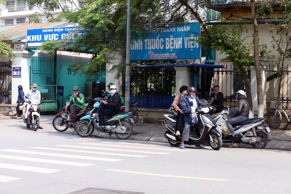 Cảnh tụ tập đông người không đúng giãn cách xã hội trước cổng Bệnh viện Thanh Nhàn. (Ảnh: Anh Tuấn/TTXVN)