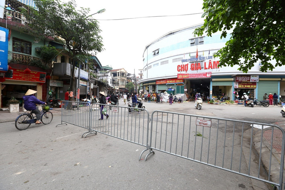 Lập hàng rào trước cổng vào chợ Gia Lâm (Long Biên). (Ảnh: Minh Quyết/TTXVN)