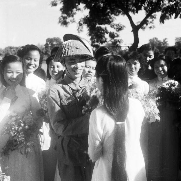 Thiếu tướng Vương Thừa Vũ, Tư lệnh Đại đoàn 308, Chủ tịch Ủy ban Quân chính Thành phố giữa vòng vây của các nữ sinh trường Trưng Vương tặng hoa chúc mừng bên hồ Hoàn Kiếm trong ngày giải phóng Thủ đô. (Nguồn: Tư liệu TTXVN)