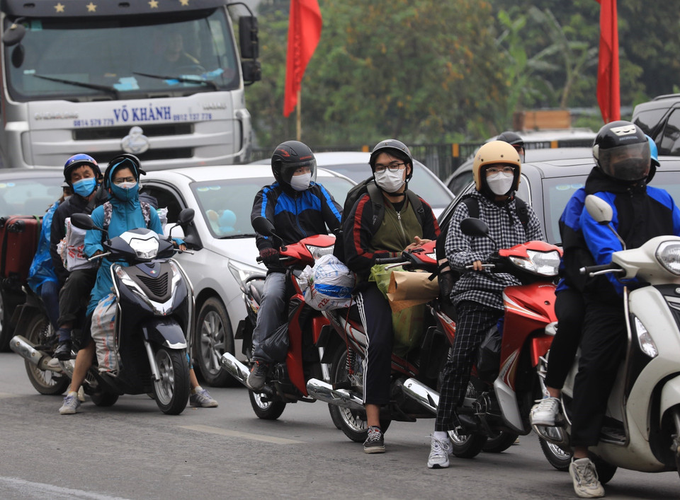 Trên trục đường Giải Phóng, người ta dễ dàng bắt gặp hình ảnh người đi xe máy với đồ đạc chằng buộc trở về Hà Nội sau kỳ nghỉ lễ. (Ảnh: Hoàng Hiếu/TTXVN)