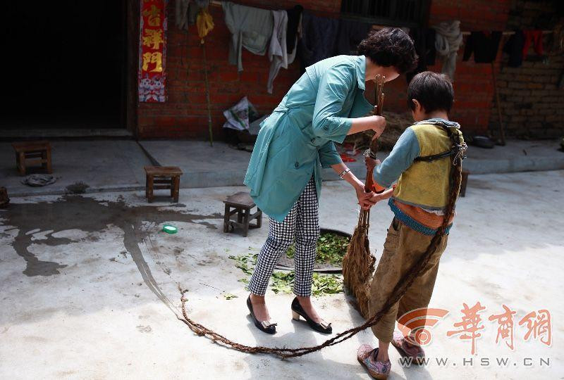 Sau khi nhận được lời khuyên từ tình nguyện viên, người nhà đã để cô bé tự do đi lại. Nhưng cô bé đã không còn chạy nhảy như trước kia, chỉ ngồi một chỗ. Bức ảnh được chụp khi Tiểu Vũ quét sân cùng một bác sỹ tư vấn tâm lý. (Nguồn: hsw.cn)