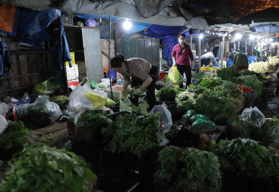 Ý thức chấp hành của một số người dân và tiểu thương kinh doanh tại chợ vẫn còn chưa cao trong việc đeo khẩu trang phòng chống dịch bệnh. (Ảnh chụp sáng 1/2/2021). (Ảnh: Vũ Sinh/TTXVN)