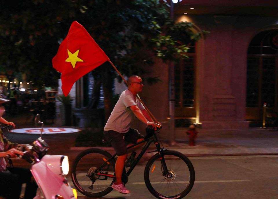 Nhiều người dân Thủ đô ra đường mang theo cờ tổ quốc để ăn mừng chiến thắng của đội Bóng đá nam U23 Việt Nam. (Ảnh: Phạm Kiên/TTXVN)