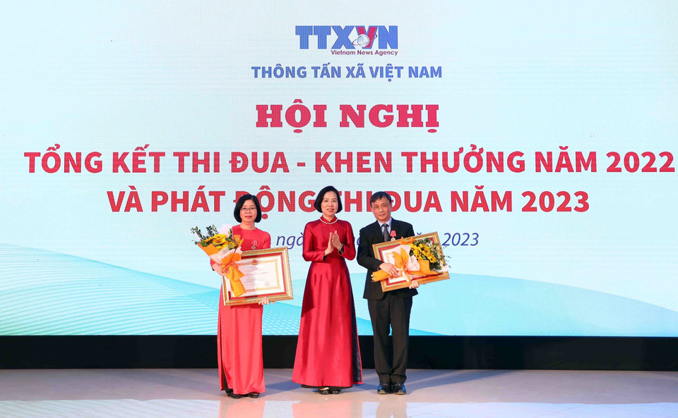 Tổng Giám đốc Thông tấn xã Việt Nam Vũ Việt Trang thừa ủy quyền của Chủ tịch nước trao Huân chương Lao động hạng Nhất cho nguyên Phó Bí thư chuyên trách Đảng ủy TTXVN Hà Thị Mai An (bên trái) và Huân chương Lao động hạng Nhì cho nguyên Chánh Văn phòng TTXVN Đào Đức Huệ (bên phải). (Ảnh: Phạm Kiên/TTXVN)