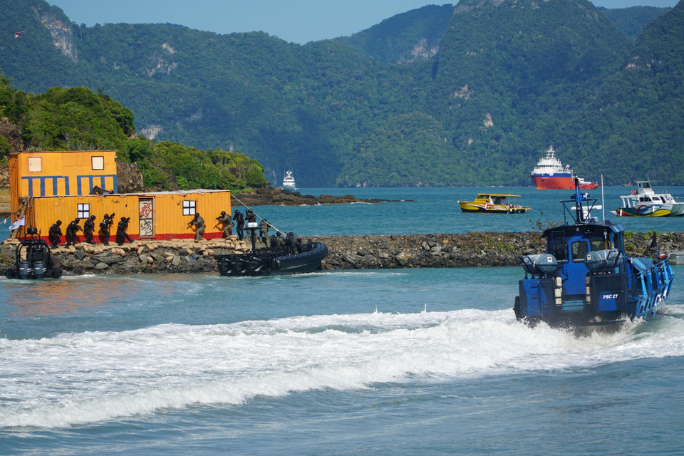 Màn trình diễn kết hợp giữa tàu cảnh sát biển, máy bay trực thăng và tàu hải quân trong hoạt động chống khủng bố. (Ảnh: Hằng Linh/TTXVN)