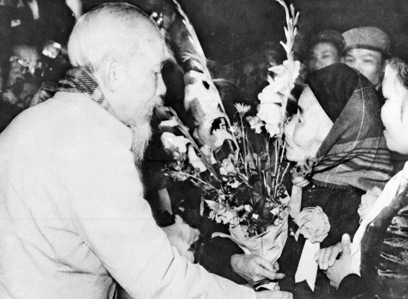 Chủ tịch Hồ Chí Minh tặng hoa cụ Đào Thị Phấn ở Cao Bằng, người mẹ của 6 con là bộ đội, về dự Đại hội liên hoan anh hùng, chiến sĩ thi đua tòan quốc lần thứ IV (1966). (Ảnh: TTXVN)