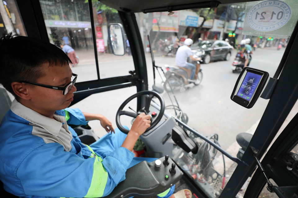 Công nhân của URENCO vận hành xe hút bụi, quét rác mini. (Ảnh: Thanh Tùng/TTXVN)