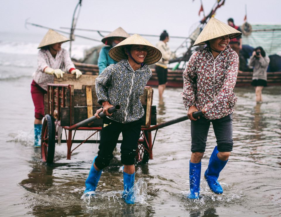 Niềm vui của những người phụ nữ sau một chuyến đi biển bội thu. (Ảnh: Thanh Dung/Vietnam+)