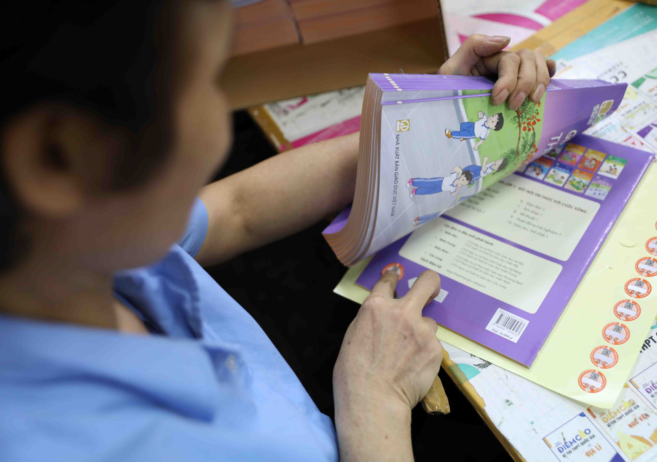Sử dụng tem chống giả công nghệ 4.0 cho sách giáo khoa mới nhằm hỗ trợ học sinh, giáo viên khai thác các học liệu điện tử kèm theo sách giáo khoa và hạn chế sách giả, sách in lậu. (Ảnh: Thanh Tùng/TTXVN)
