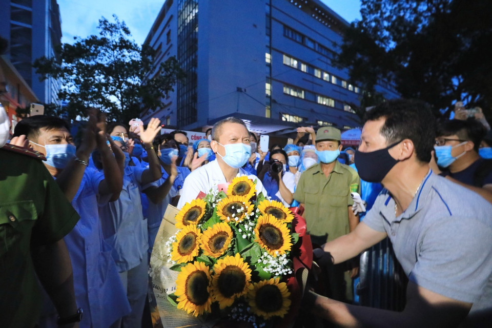 Người dân tặng hoa chúc mừng Bệnh viện E (Hà Nội) dỡ bỏ cách ly. (Ảnh: Thành Đạt/TTXVN)