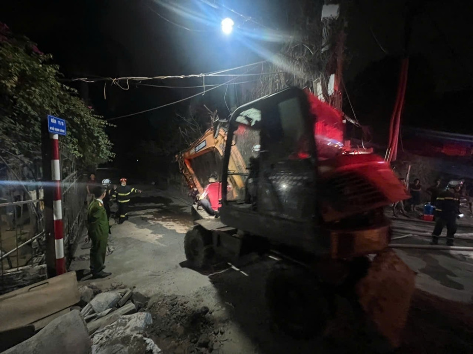 Lực lượng phòng cháy chữa cháy điều xe xúc đến hiện trường để tìm cách tiếp cận đám cháy. (Ảnh: Phạm Kiên/TTXVN)