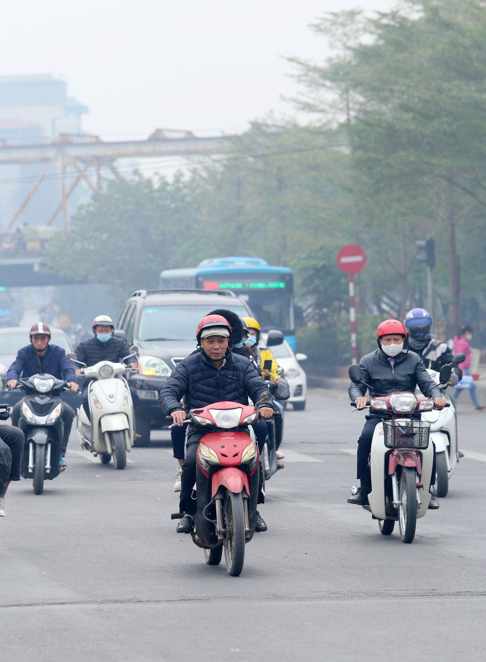 Một số người dân vẫn chủ quan không đeo khẩu trang khi ra đường trong thời điểm ô nhiễm không khí và dịch COVID-19. (Ảnh: Hoàng Hiếu/TTXVN)