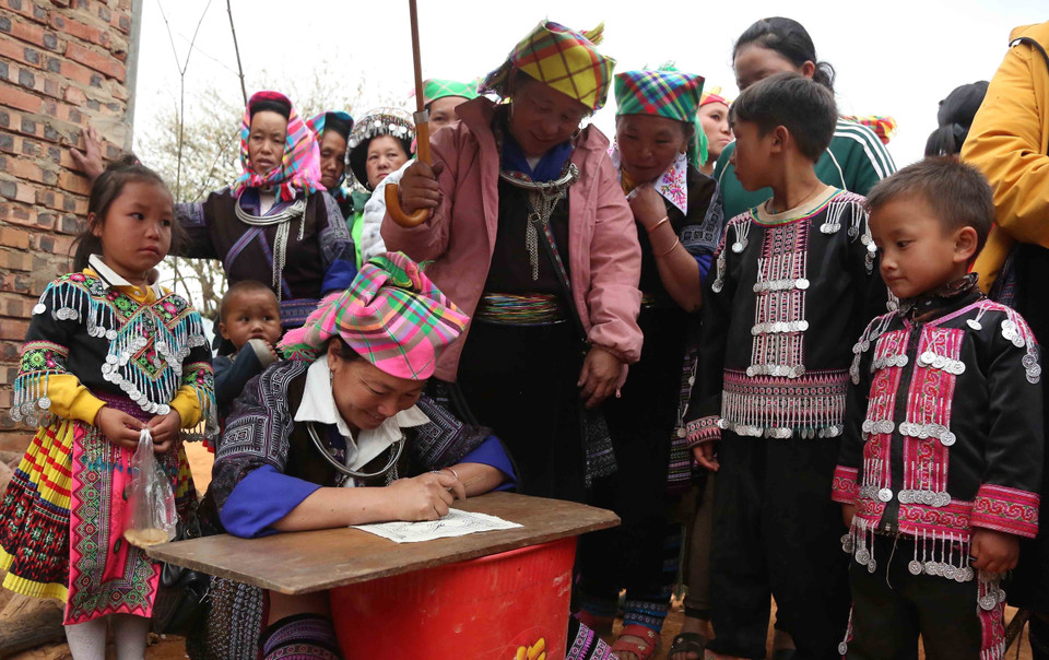 Đồng bào dân tộc thi vẽ sáp ong trên vải tại Ngày hội. (Ảnh: Quang Quyết/TTXVN)