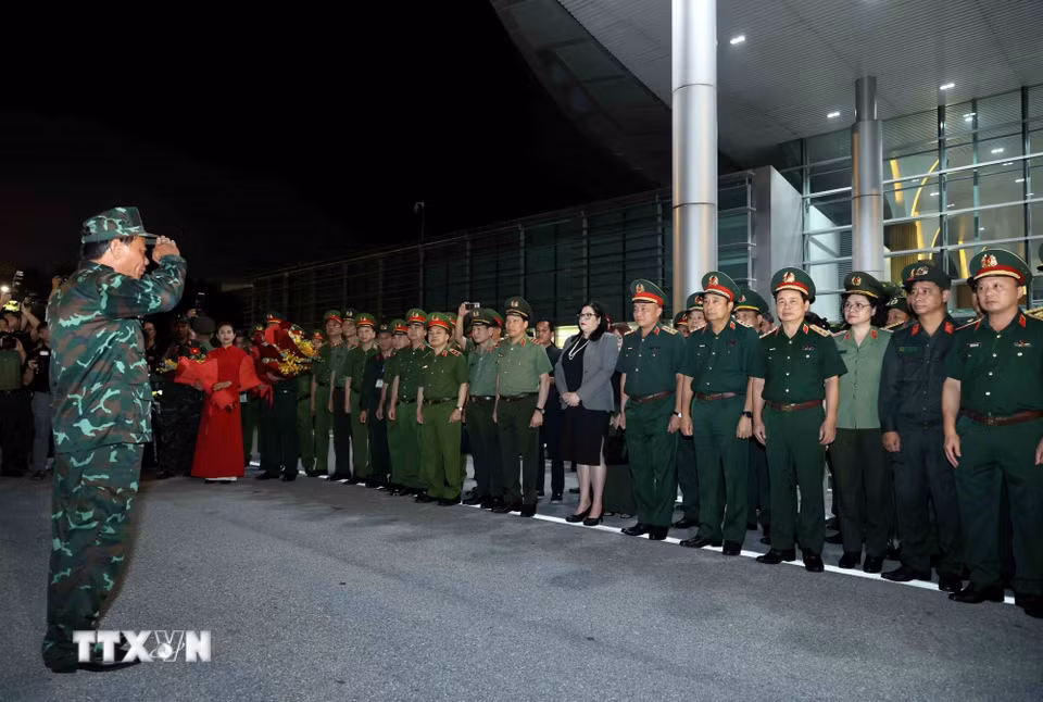 Lãnh đạo Bộ Quốc phòng và lãnh đạo Bộ Công an đón Đoàn cứu nạn, cứu hộ Việt Nam. (Ảnh: An Đăng/TTXVN)