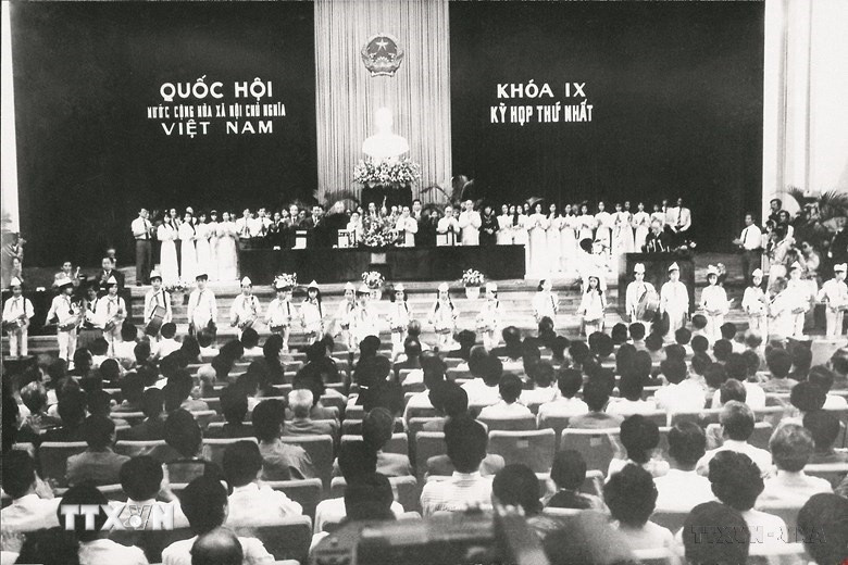 Quốc hội khóa IX (1992-1997) được bầu ngày 19/7/1992, gồm có 395 đại biểu, nhiệm kỳ hoạt động là 5 năm. Đồng chí Nông Đức Mạnh được bầu làm Chủ tịch Quốc hội. Quốc hội khóa IX đã đóng vai trò quan trọng trong việc thể chế hóa Cương lĩnh xây dựng đất nước trong thời kỳ quá độ lên chủ nghĩa xã hội, Chiến lược ổn định và phát triển kinh tế - xã hội, đường lối đổi mới của Đảng theo tinh thần Hiến pháp năm 1992 và Nghị quyết của Đại hội Đảng toàn quốc lần thứ VII. Trong ảnh: Đoàn thiếu nhi Thủ đô đến chào mừng các đại biểu Quốc hội khóa IX trong phiên khai mạc Kỳ họp thứ nhất, ngày 20/9/1992. (Ảnh: TTXVN)