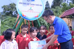 Bí thư Trung ương Đoàn, Chủ tịch Trung ương Hội Liên hiệp thanh niên Việt Nam Nguyễn Tường Lâm trao quà cho các em học sinh. (Ảnh: PV/Vietnam+)