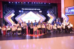 Ban tổ chức trao tặng bằng khen cho 25 thanh niên khuyết tật tiêu biểu. (Ảnh: PV/Vietnam+)