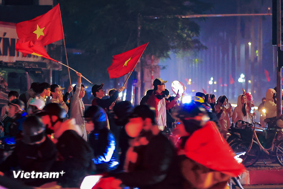Khắp các tuyến phố rợp cờ đỏ sao vàng sau màn "đấu súng" tại loạt luân lưu đem lại chiến thắng cho U23 Việt Nam. (Ảnh: Hoài Nam/Vietnam+)