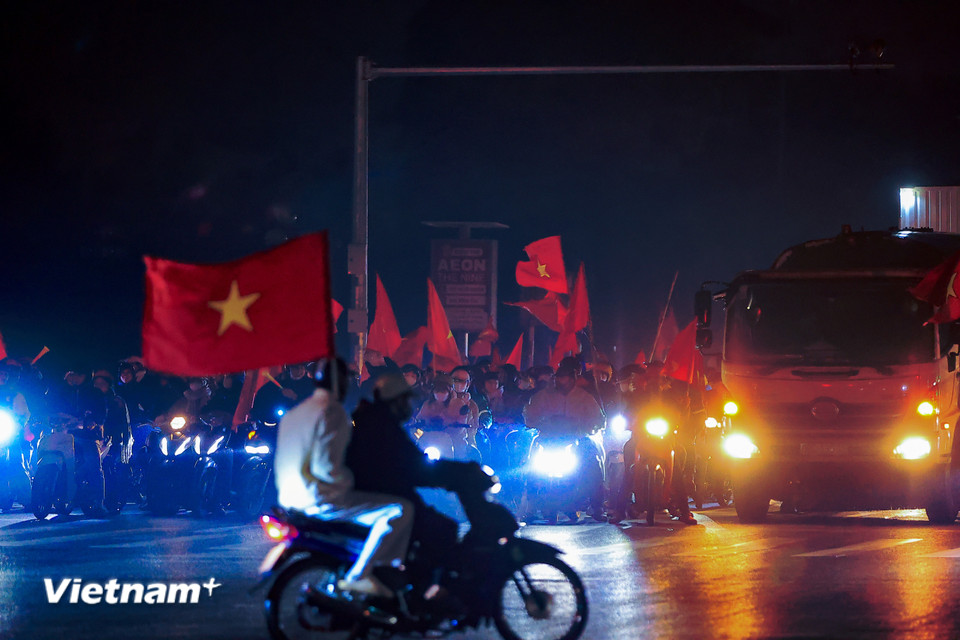 Tại khu vực gần sân vận động Quốc gia Mỹ Đình, rất nhiều cổ động viên đội nhà cùng lá cờ đỏ sao vàng xuống đường ăn mừng chiến thắng. (Ảnh: Hoài Nam/Vietnam+)
