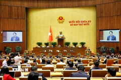 Bộ trưởng Bộ Công an Lương Tam Quang, thừa ủy quyền của Thủ tướng Chính phủ trình bày Báo cáo công tác phòng, chống tội phạm và vi phạm pháp luật năm 2025. (Ảnh: Doãn Tấn/TTXVN)