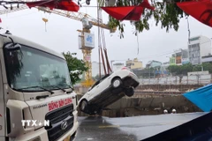 Xe ô tô được giải cứu khỏi "hố tử thần." (Ảnh: Quốc Dũng/TTXVN)