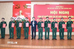 Trao Quyết định điều động, bổ nhiệm 96 sỹ quan quân đội về các xã, phường, đặc khu ở Quảng Ngãi. (Ảnh: TTXVN phát)