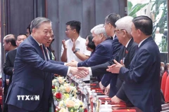 Tổng Bí thư Tô Lâm và các đại biểu tham dự buổi gặp mặt. (Ảnh: Phương Hoa/TTXVN)
