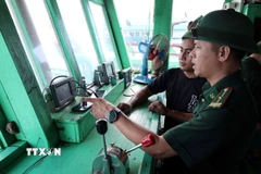 Cán bộ, chiến sỹ Đồn Biên phòng Sơn Trà (Ban chỉ huy Bộ đội Biên phòng thành phố Đà Nẵng) kiểm tra các thiết bị thông tin liên lạc trên tàu cá của ngư dân. (Ảnh: Đỗ Trưởng/TTXVN)