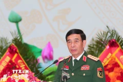 Đại tướng Phan Văn Giang, Ủy viên Bộ Chính trị, Phó Bí thư Quân ủy Trung ương, Bộ trưởng Bộ Quốc phòng trình bày Báo cáo chính trị. (Ảnh: Trọng Đức/TTXVN)