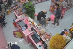 2 đối tượng dùng dao khống chế nhân viên cửa hàng quà tặng cướp tài sản. (Ảnh: TTXVN phát)