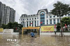 Đoạn phố phía trước UBND phường Cầu Giấy nước ngập sâu, các phương tiện không thể đi qua. (Ảnh: Huy Hùng/TTXVN)