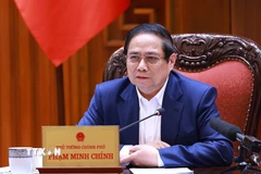 Thủ tướng Phạm Minh Chính chủ trì họp triển khai kế hoạch phân cấp, phân quyền khi thực hiện mô hình tổ chức chính quyền địa phương 2 cấp. (Ảnh: Dương Giang/TTXVN)