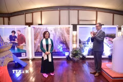 Đại sứ Cộng hòa Pháp tại Việt Nam Olivier Brochet chúc mừng Giáo sư-Tiến sỹ Đinh Thị Mai Thanh nhận Huân chương Cành cọ Hàn lâm. (Ảnh: TTXVN phát)