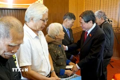 Phó Chủ tịch Quốc hội Nguyễn Đức Hải (phải) tặng quà cho các gia đình chính sách, người có công tại xã Tam Xuân (thành phố Đà Nẵng). (Ảnh: Quốc Dũng/TTXVN)