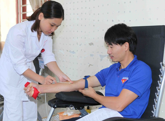 Tình nguyện viên, đoàn viên, thanh niên, cán bộ công nhân viên chức tham gia hiến máu. (Ảnh: TTXVN) Rộn ràng ngày hội hiến máu Giọt hồng sông Đà lần thứ I ảnh 1