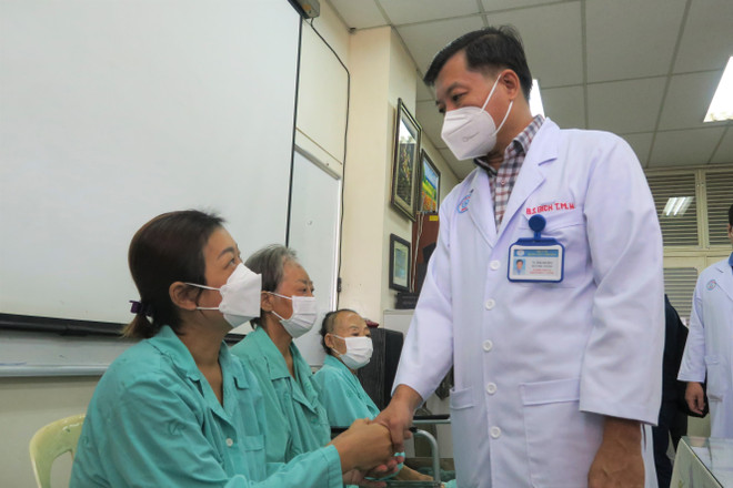 Bác sỹ tại Bệnh viện Chợ Rẫy chúc mừng và dặn dò các bệnh nhân bị hoại tử xương vùng hàm mặt trước khi xuất viện. (Ảnh: Đinh Hằng/TTXVN) Lập hội đồng xác định nguyên nhân gây bệnh hoại tử xương hàm mặt ảnh 1