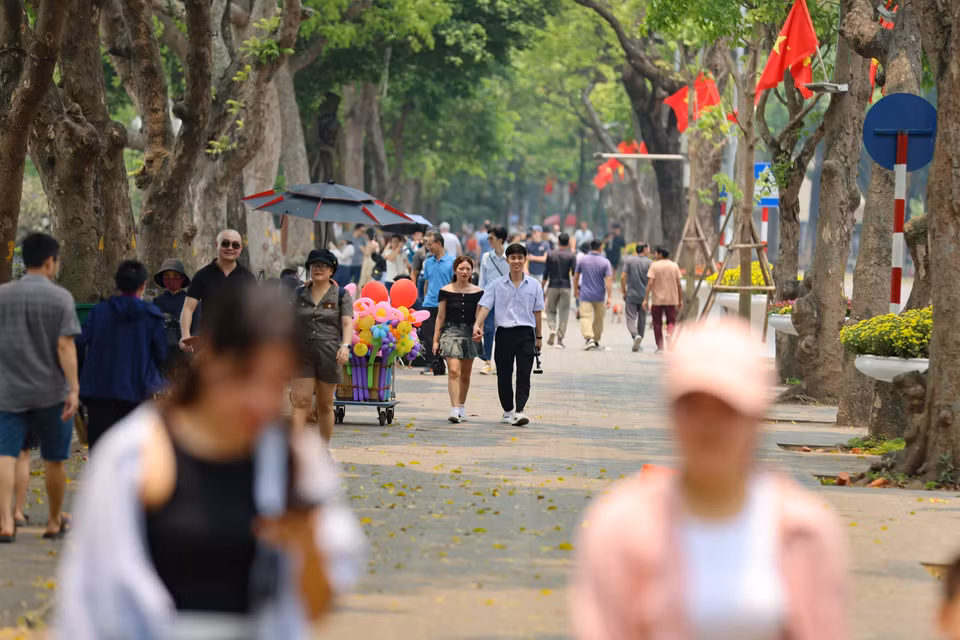 Dù nắng nóng nhưng người dân và du khách vẫn dạo bước, ngắm cảnh bên hồ. (Ảnh: Thanh Tùng/TTXVN)