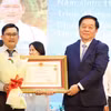 Trưởng Ban Tuyên giáo và Dân vận Trung ương Nguyễn Trọng Nghĩa trao tặng danh hiệu Thầy thuốc ưu tú cho các thầy thuốc của Bệnh viện Thống Nhất Thành phố Hồ Chí Minh. (Ảnh: Đinh Hằng /TTXVN)