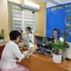 Trung tâm Phục vụ hành chính công phường Cửa Nam làm việc chuyên nghiệp, đồng bộ. (Ảnh: Nguyễn Cúc/TTXVN)