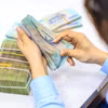 Ngân hàng đồng loạt tăng lãi suất huy động, mặt bằng 8–9%/năm dần xuất hiện. (Ảnh: Vietnam+)
