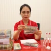 Ngân hàng rầm rộ công bố lợi nhuận đạt cao. (Ảnh: Vietnam+)