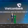 Bà Tô Thị Phương Dung - Trưởng Phòng Chính sách & Kế hoạch nhân sự đại diện Vietcombank nhận cúp "Harmonia" từ Ban tổ chức (ảnh trên) và chụp ảnh lưu niệm cùng đại diện lãnh đạo các đơn vị Vietcombank tham dự sự kiện (ảnh dưới). (Ảnh: Vietnam+)