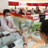 Áp lực thanh khoản đẩy lãi suất huy động tăng. (Ảnh: Vietnam+)