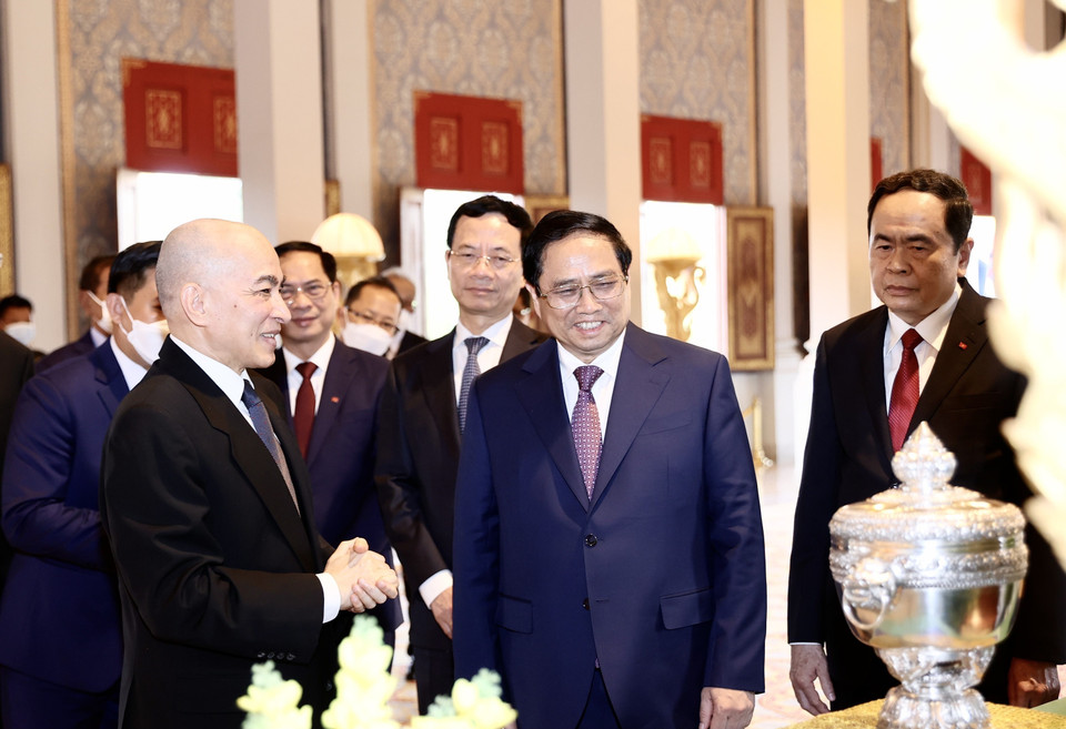 Quốc vương Campuchia Norodom Sihamoni giới thiệu với Thủ tướng Phạm Minh Chính một số tặng phẩm của Hoàng cung. (Ảnh: Dương Giang/TTXVN)